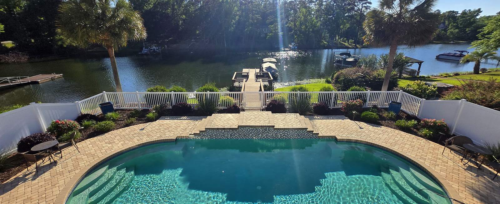 White vinyl pool fence around a backyard pool on a lake in Irmo, SC