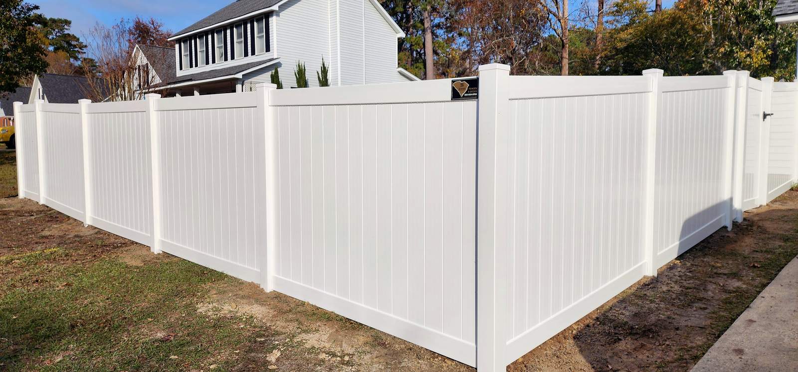White vinyl privacy fence beside a two story home in the Midlands of SC
